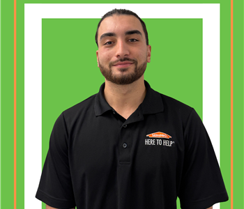 A SERVPRO employee is shown in a SERVPRO black shirt