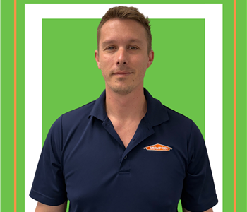 A SERVPRO employee is shown in a blue shirt with SERVPRO logo