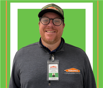 A SERVPRO employee is shown in a grey shirt with SERVPRO logo