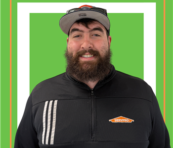 A SERVPRO employee is shown in a black shirt with SERVPRO logo