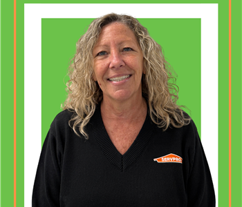 A SERVPRO employee is shown in a black shirt