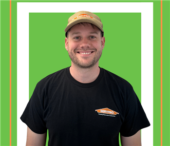 A SERVPRO employee is shown in a black shirt with SERVPRO logo