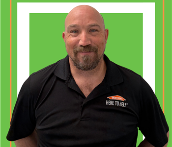 A SERVPRO employee is shown in a black shirt with SERVPRO logo