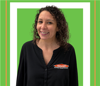 A SERVPRO employee is shown in a black shirt with SERVPRO logo