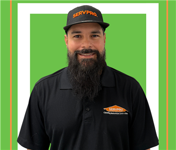 A SERVPRO employee is shown in a black shirt with SERVPRO logo