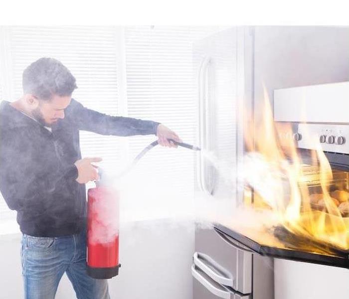A person is shown using a fire extinguisher to put out a stove fire 