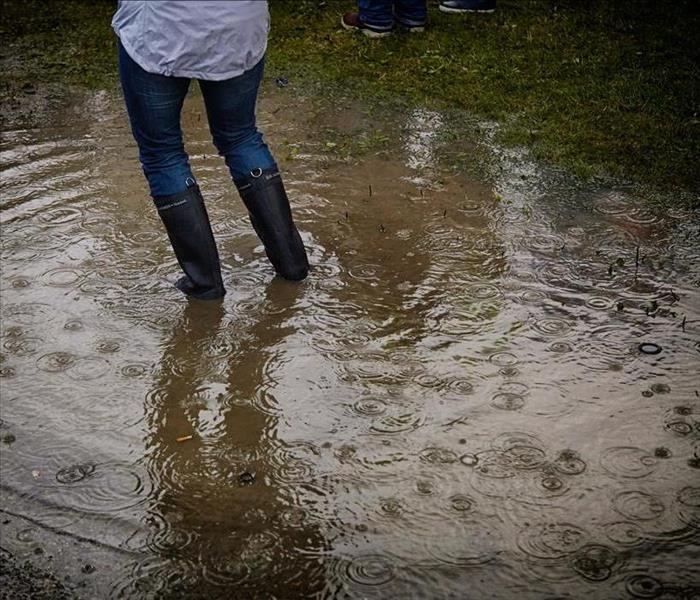 Woman standing in puddle